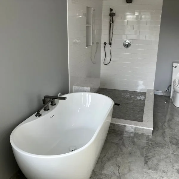 new bathroom remodel with a shower and tub
